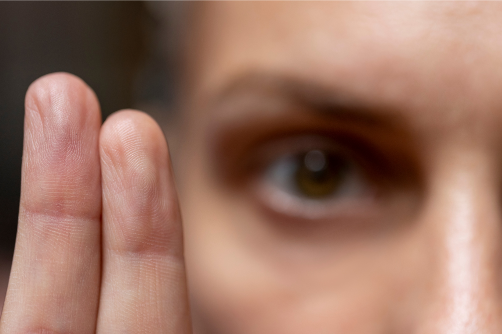 Close-up of a person holding up two fingers during EMDR therapy, sometimes used in rehab for substance abuse