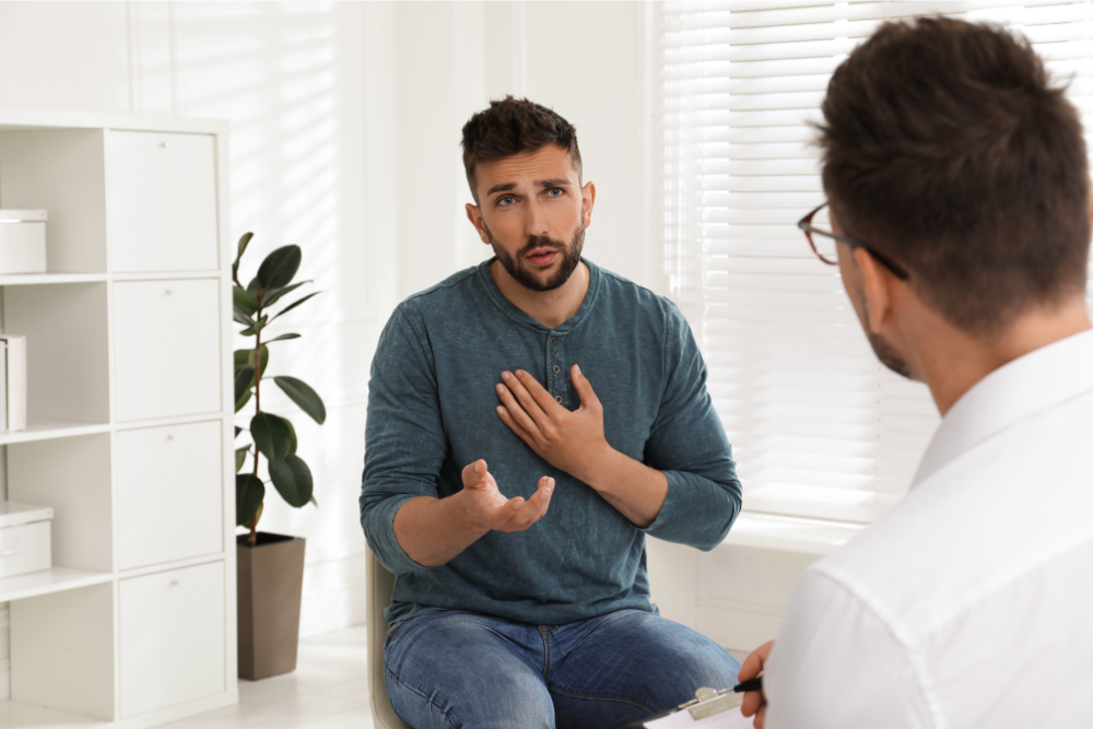 A male drug addict speaks passionately during a session with his therapist. Rehab can involve many types of therapy